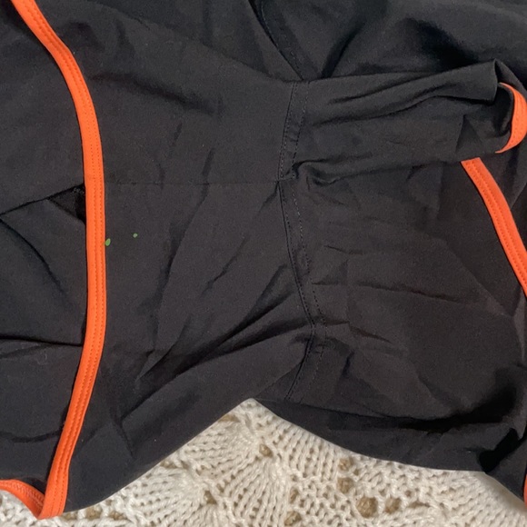 Black North Face running shorts with orange and blue accents - Picture 4 of 4